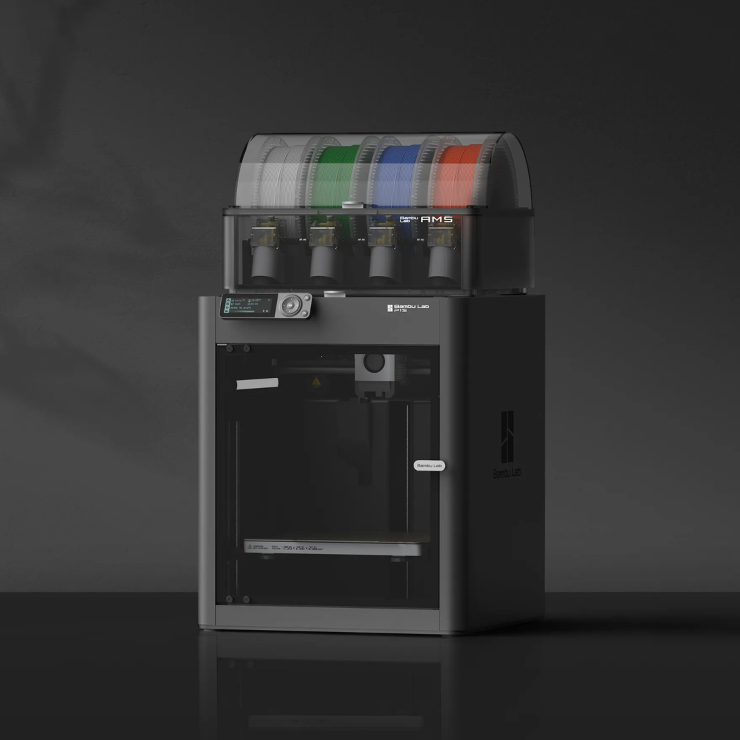3D printer with colorful filament spools on a dark background